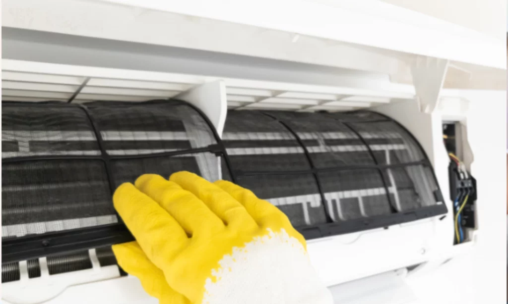 Technician cleaning an Aircon filters