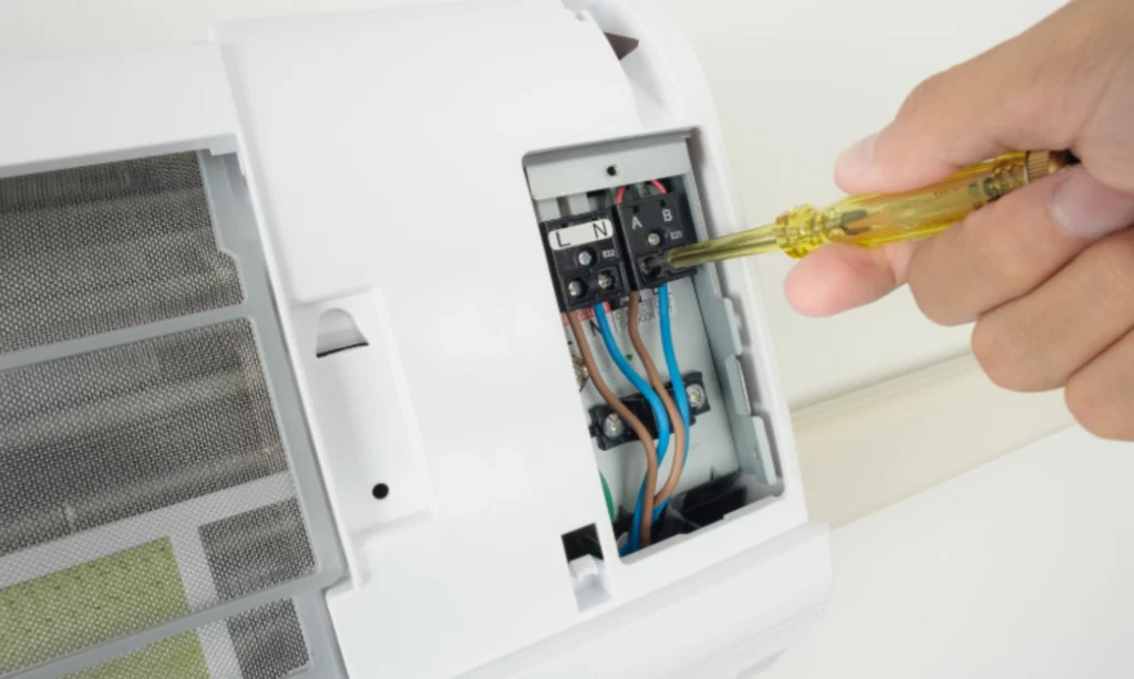 Technician repairing an Aircon